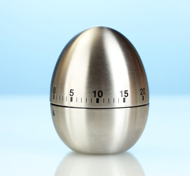 Metal Kitchen Egg Timer On A Blue Background