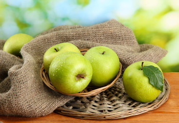 Ripe green apples in basket
