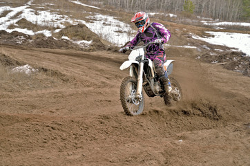 Obraz premium Motocross rider on a motorcycle rides cornering
