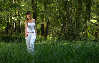 girl walking through the grass