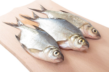 Fish fry on a wooden board. Isolated on white