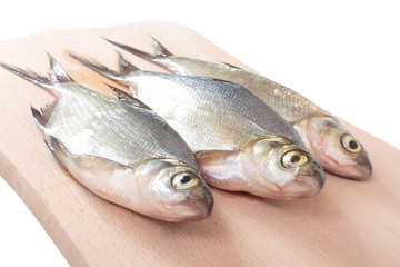 Fish fry on a wooden board. Isolated on white