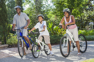 African American Parents WIth Boy Son Riding Bike