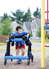 Disabled boy in walker walking up to playground