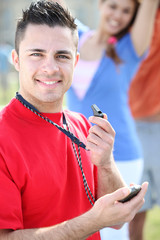 young referee all smiles holding whistle