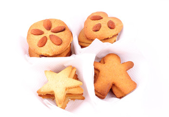 Christmas biscuits in white individual cases, isolated on white