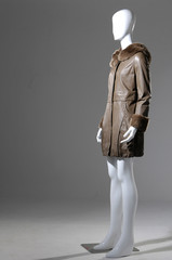 female fashion coat on mannequin a gray background