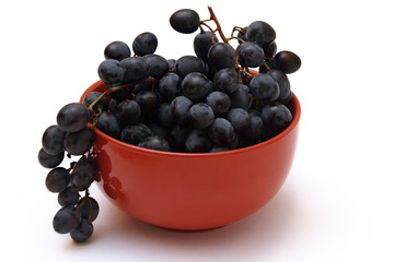 branch of grapes in the red bowl