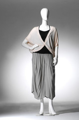 full-length female clothes on a mannequin in light background