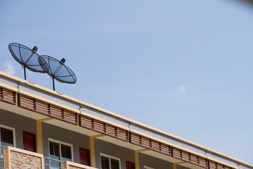twin satellite dishes on the top apartment