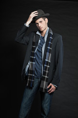 Fototapeta premium Handsome man dark winter fashion. Studio shot. Wearing hat.