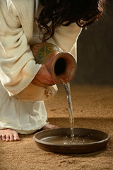 Jesus Pouring Water into Container - 46376589