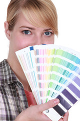 Woman choosing color of paint