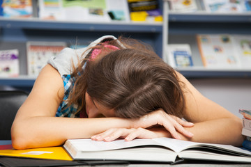 Beautiful female student in a library
