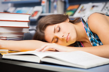 Beautiful female student in a library