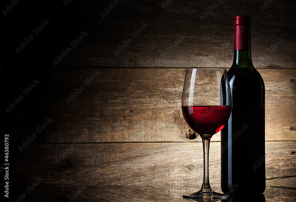 Fototapete Wine glass and Bottle on a wooden background