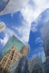 Fototapeta na wymiar Skyscrapers with clouds reflection