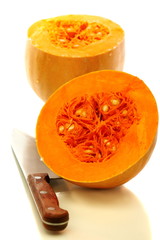 Ripe pumpkin and knife.