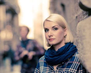 Beautiful blond woman wearing blue scarf outdoors