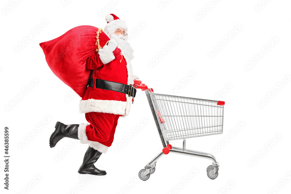 Wall mural santa claus with a bag on his shoulder pushing a shopping cart