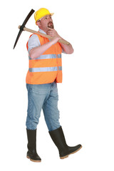 Contemplative labourer holding a pickaxe