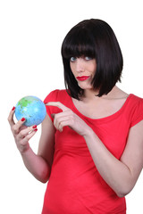 woman holding a globe and making a funny face