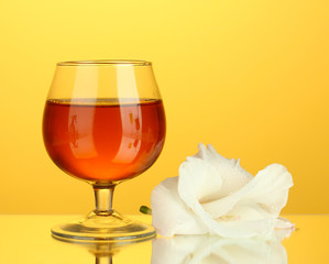 glass with cocktail and gladiolus bud