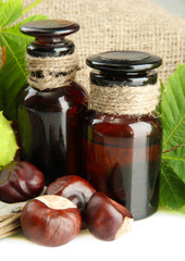 medicine bottles with chestnuts and leaves, on burlap