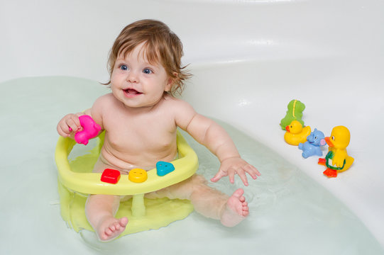 Cheery cute baby girl in a bath