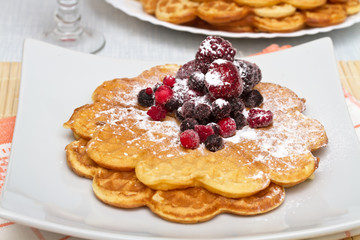 Wafers with berries and powdered sugar