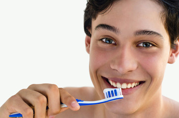 Handsome man smiling and holding a toothbrush