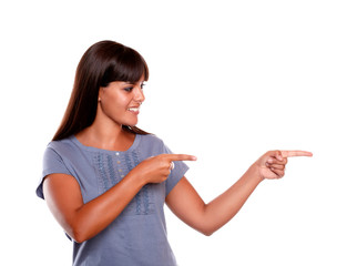 Smiling young woman looking and pointing left