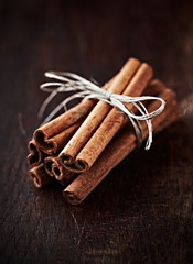 Cinnamon sticks on dark wooden background