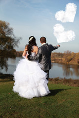 Newlyweds look at the clouds