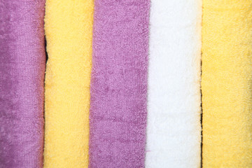 Violet, white and yellow towels