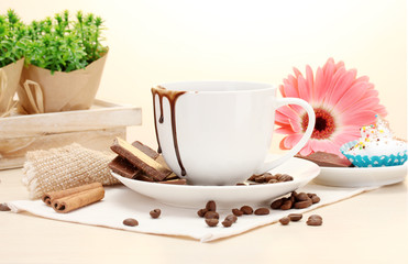 dirty cup of coffee and gerbera  beans, cinnamon sticks