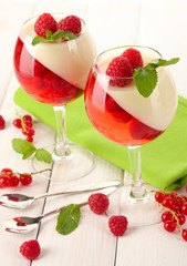 fruit jelly with berries in glasses on wooden table