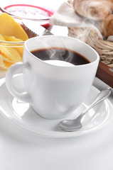 Obraz na płótnie Canvas Breakfast of coffee, croissant, jam and butter