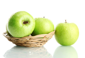 Ripe green apples in basket isolated on white