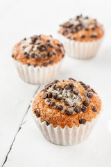 Chocolate chip muffins on white wood