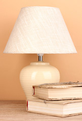 table lamp and books on beige background