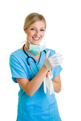 Woman in doctor uniform wearing latex gloves