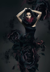 mysterious woman in dark hood and rose dress