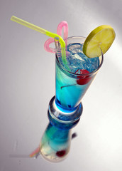 blue cocktail with ice and lime