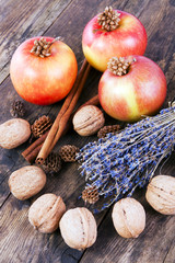 Apples, nuts and cinnamon on wooden board.