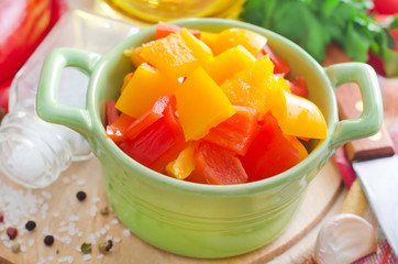 red and yellow peppers on wooden background