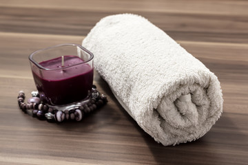 Fototapeta na wymiar Soft white cotton towel and candles. spa collection.