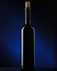 a bottle of wine on a dark background
