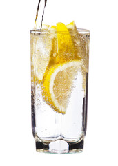 Full glass of water with lemon isolated on white background