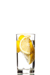Full glass of water with lemon isolated on white background